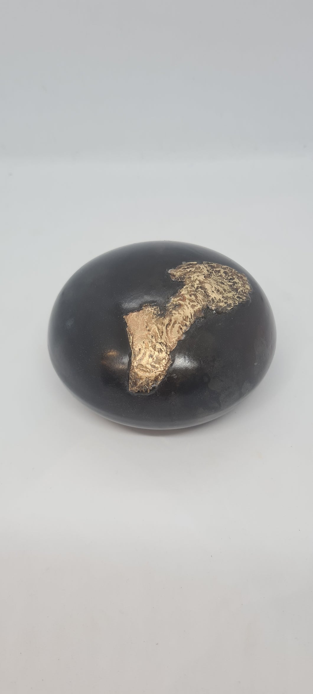 Black small spheres with brass inlay