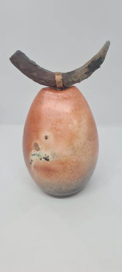 Orange and black horned totem with copper strip