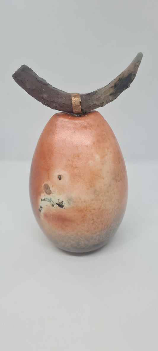 Orange and black horned totem with copper strip