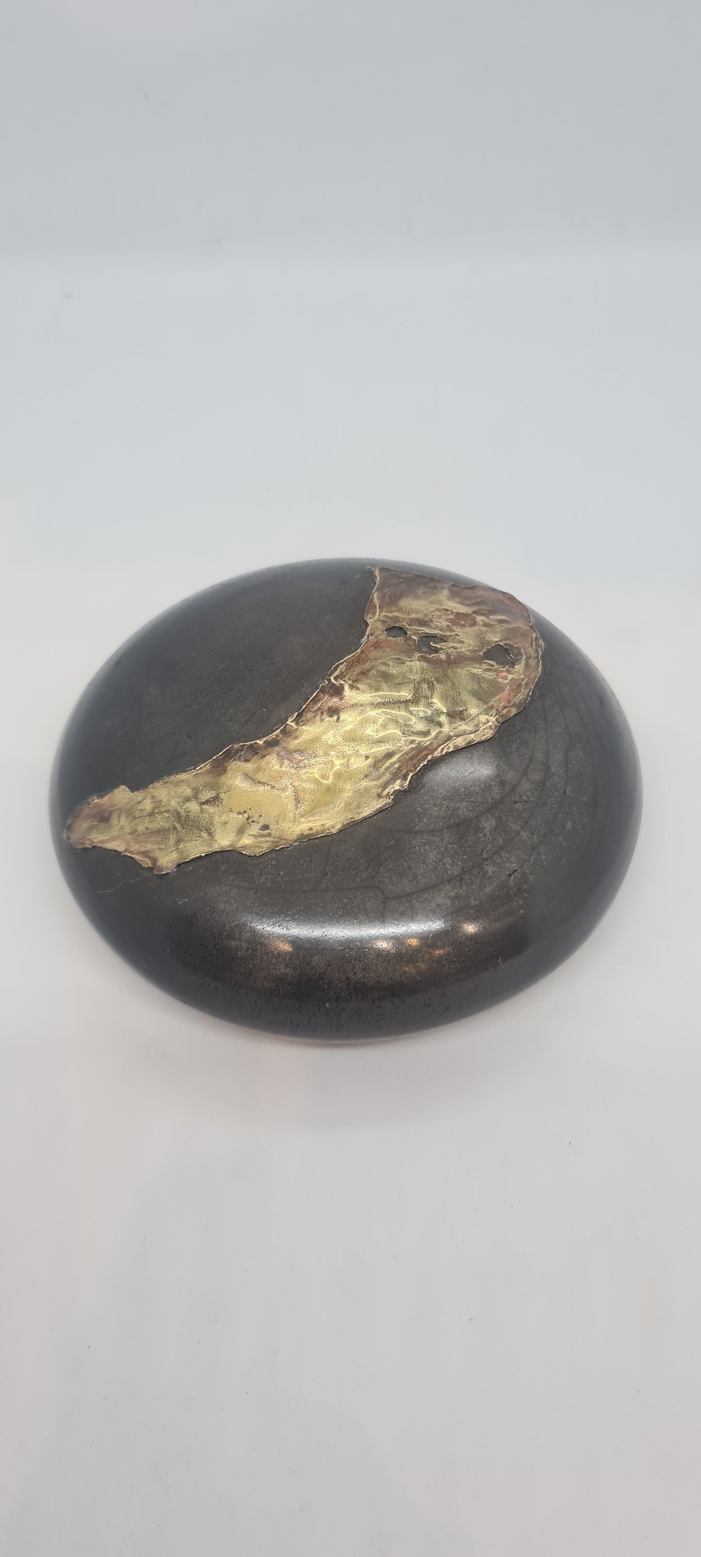 Black small spheres with brass inlay