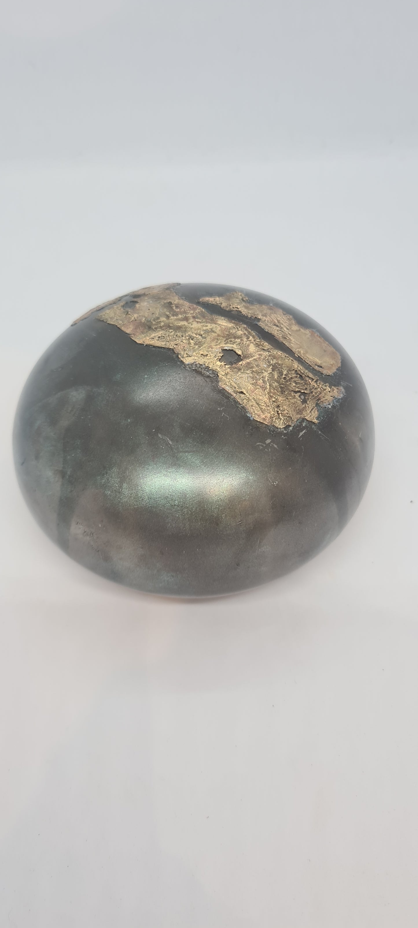 Black small spheres with brass inlay