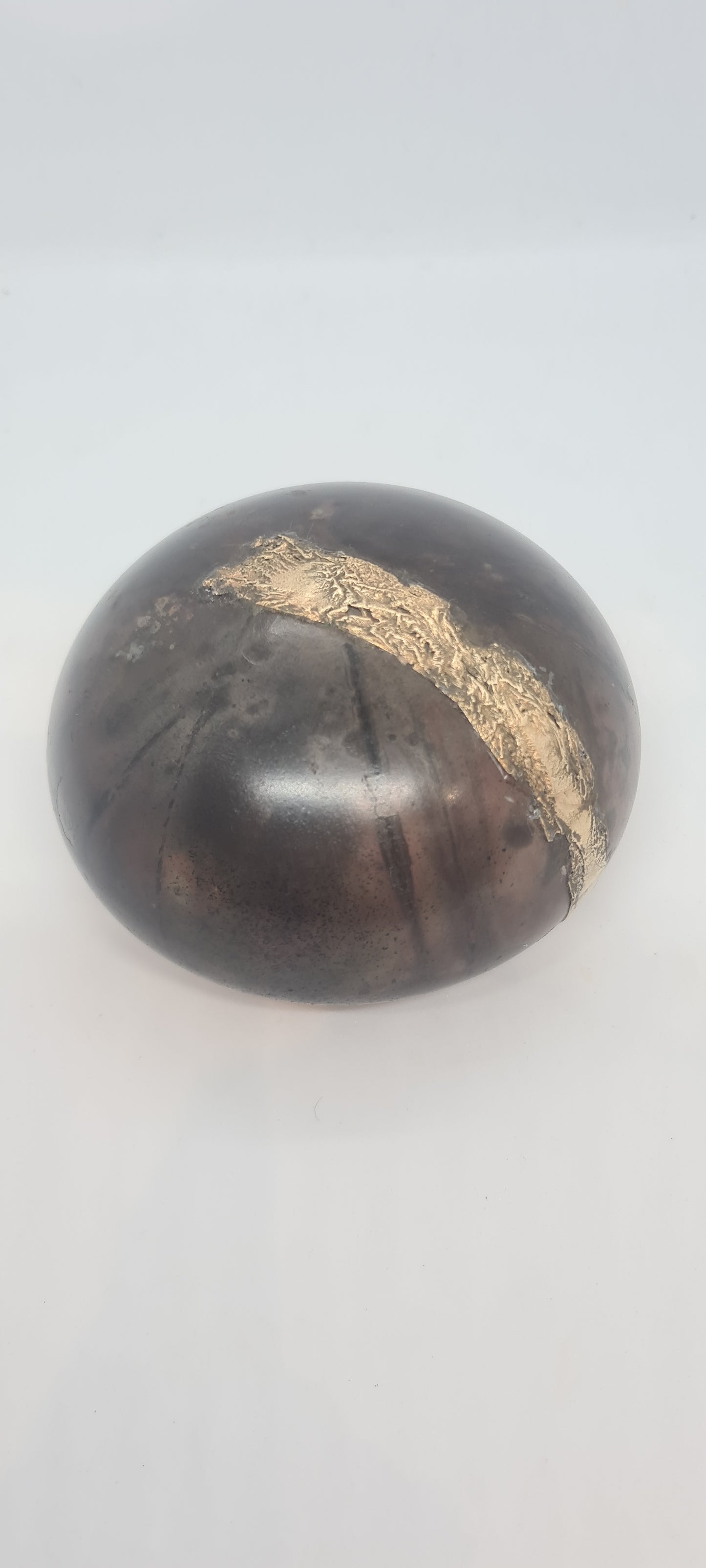 Black small spheres with brass inlay