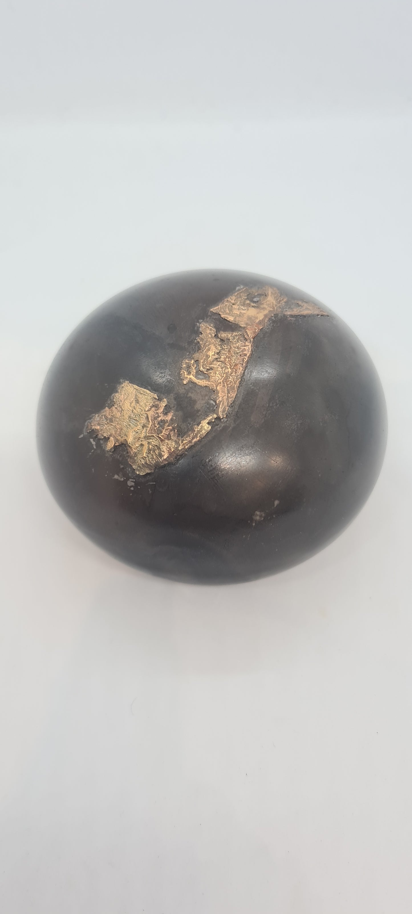 Black small spheres with brass inlay