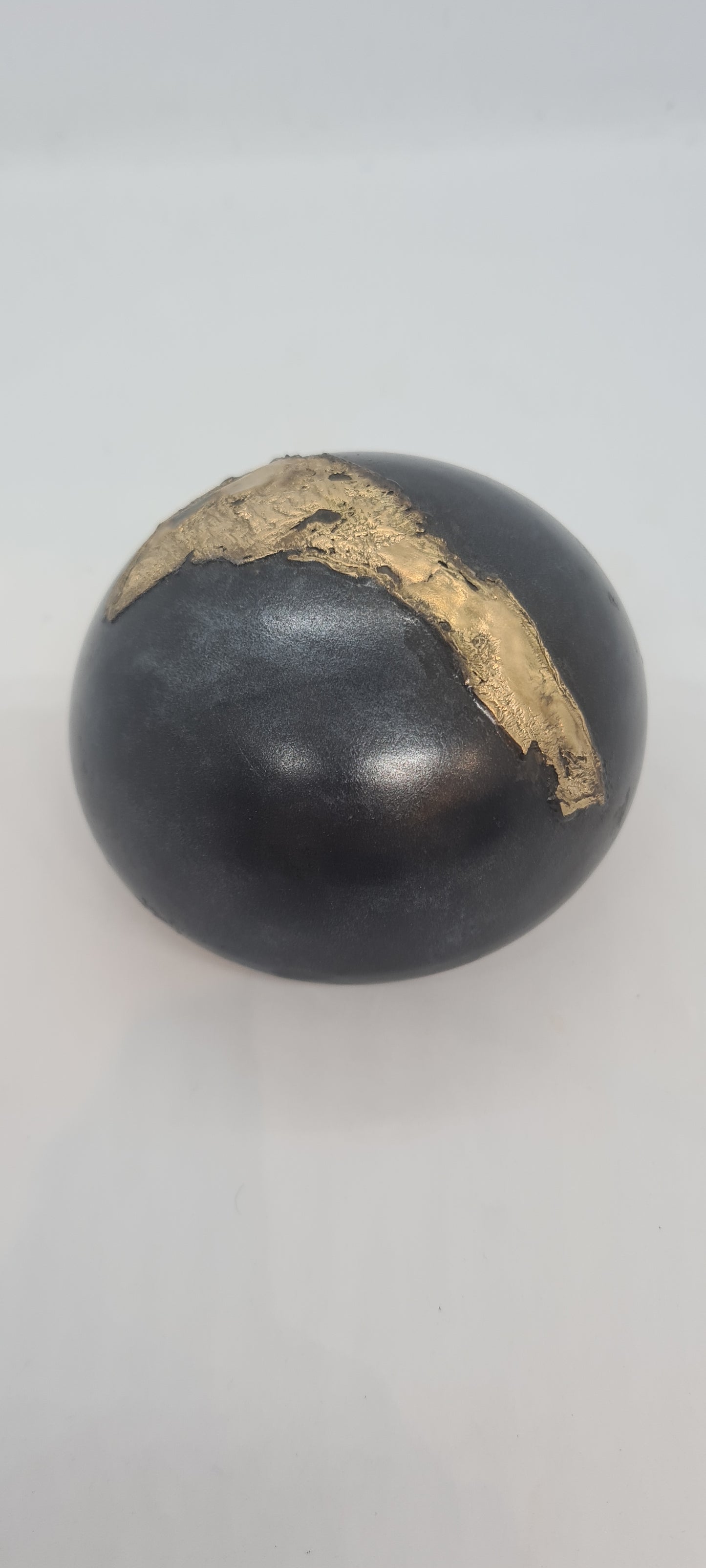 Black small spheres with brass inlay