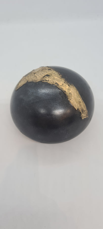 Black small spheres with brass inlay