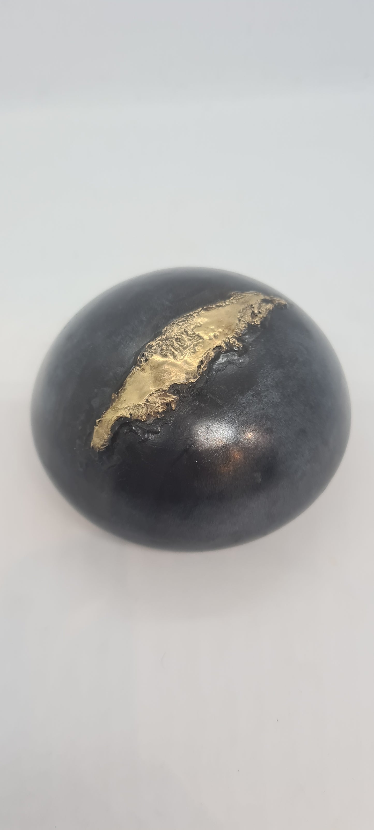 Black small spheres with brass inlay